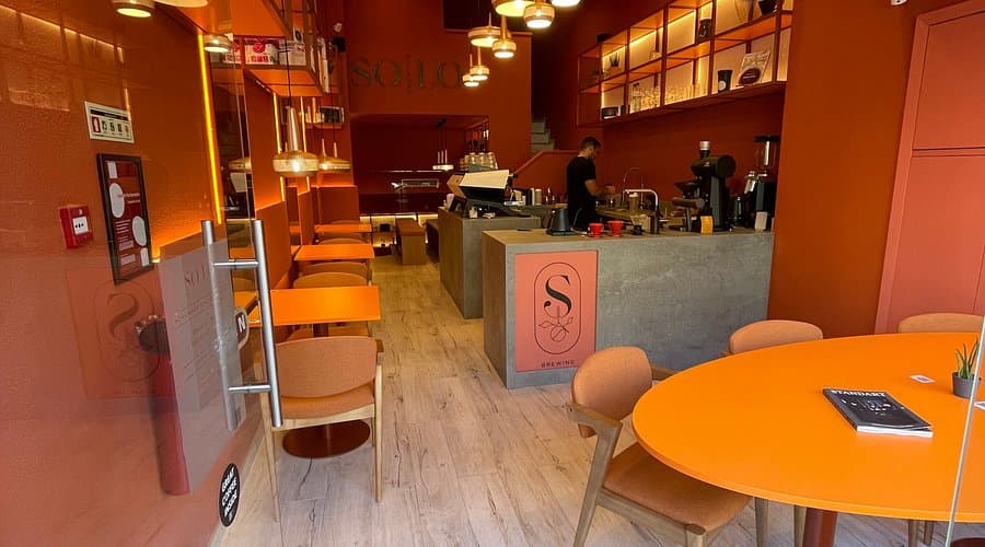 Solo Brewing coffee bags on the counter with warm orange interior